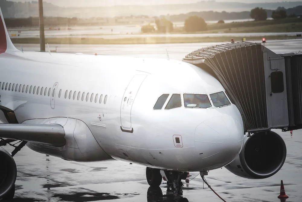 An airliner parked at a boarding bridge