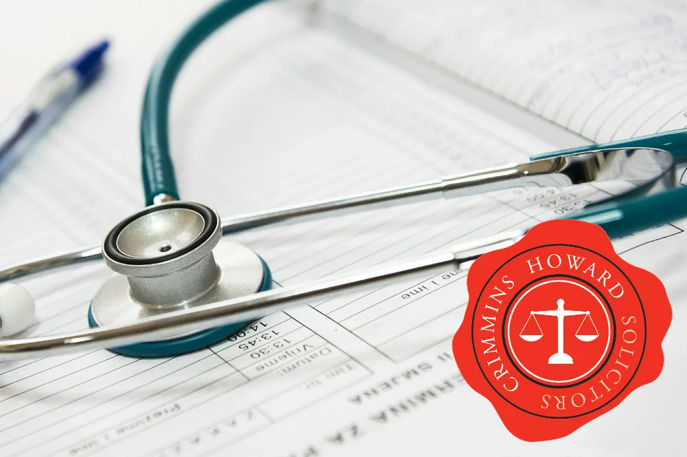 A stethoscope resting on medical notes, with the Crimmins Howard seal
